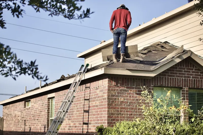 Professional roofer working on a residential roof in Green Camp